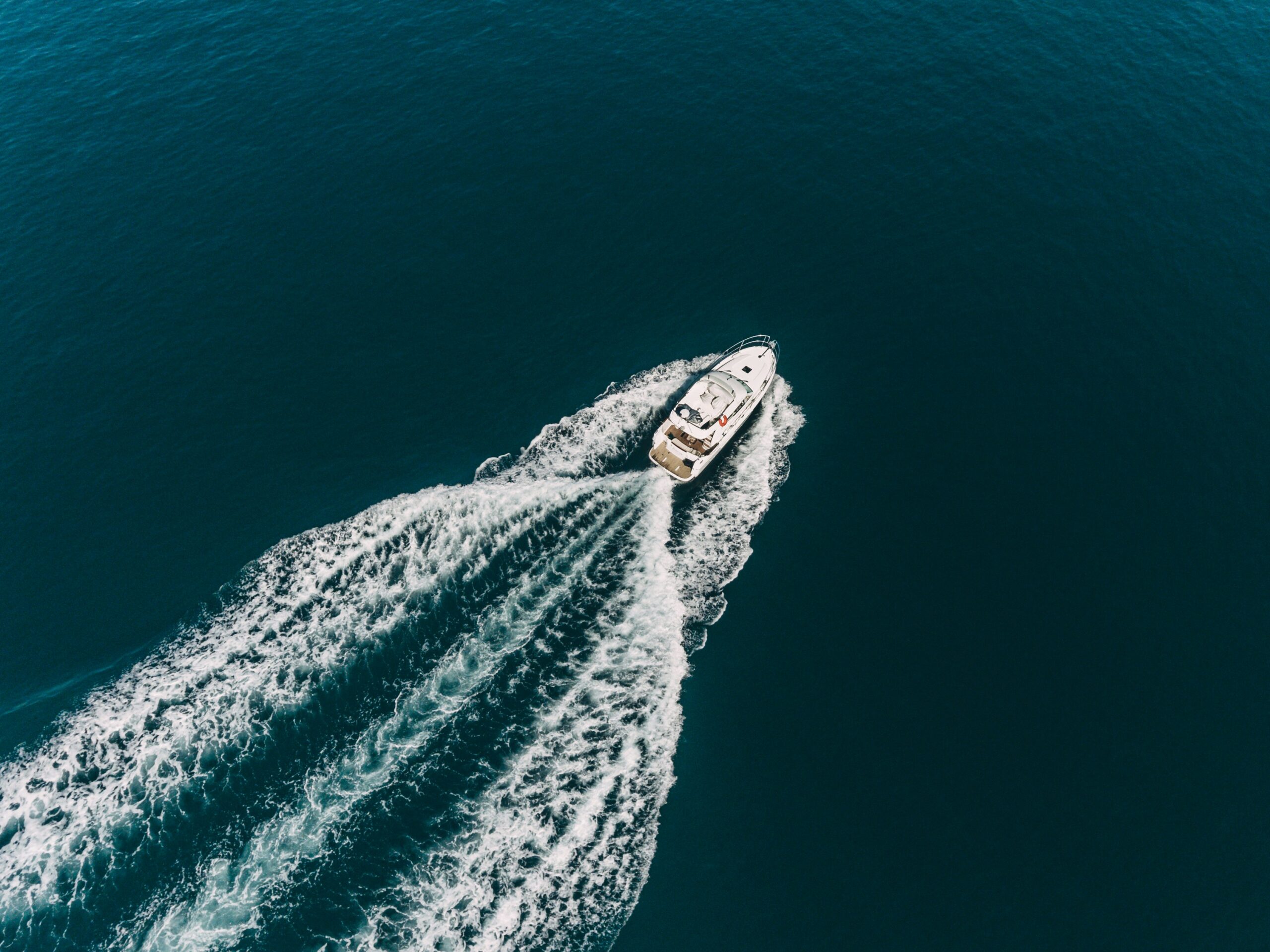 A yacht in the middle of the blue ocean