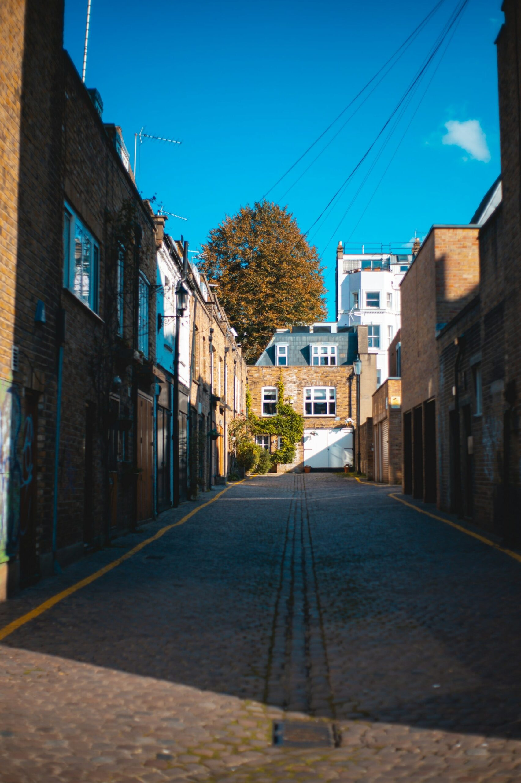 A mews in London surrounded by bright blue sky